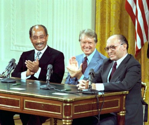 Egyptian President Anwar Sadat, US President Jimmy Carter, and Israeli Prime Minister Menachem Begin sign the Camp David Accords, September 17, 1978